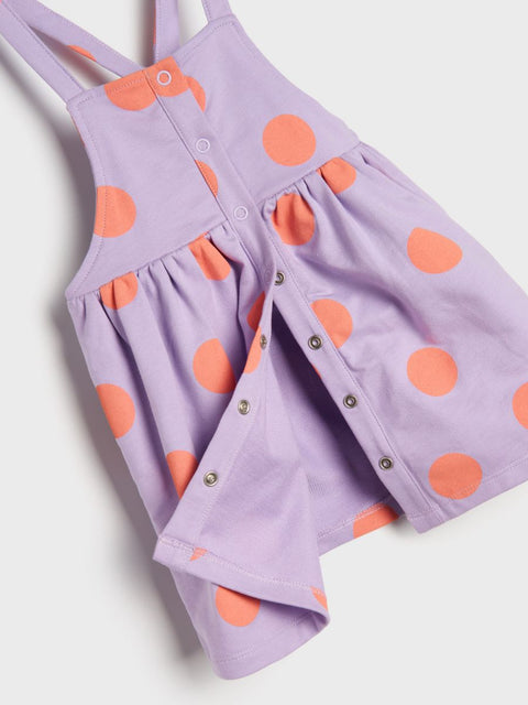 Purple dress with orange polka dots on a white background