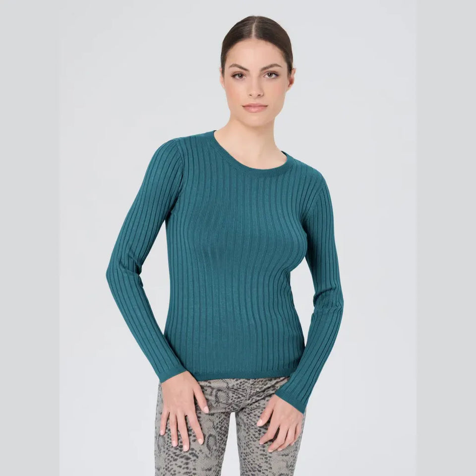 A woman modeling a teal ribbed long-sleeve crewneck sweater against a light gray studio background.