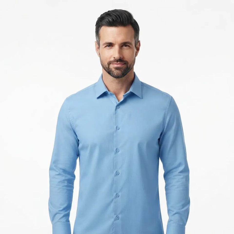 A man wearing a light blue long-sleeve button-down shirt, photographed against a clean white studio background.