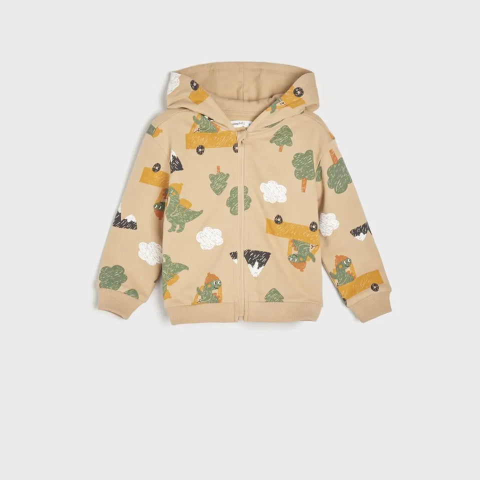 A children's beige zip-up hoodie with an all-over dinosaur and truck print, displayed flat against a light gray background.