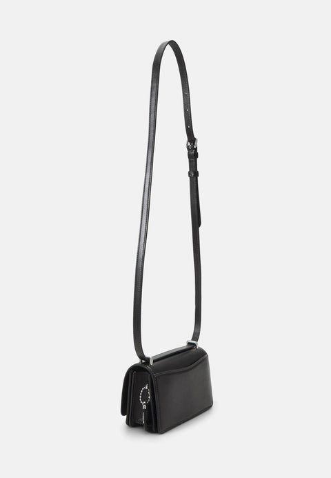 Black handbag with a strap on a light gray background