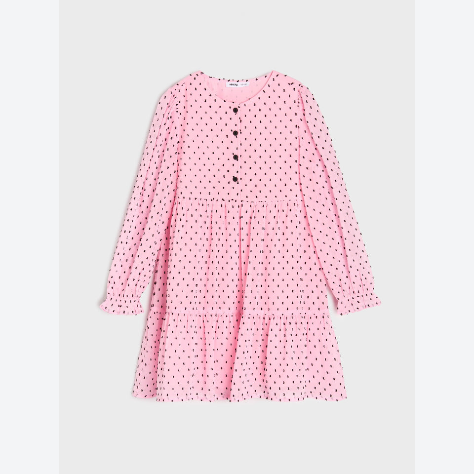 A pink long-sleeve tiered dress with a small black polka dot pattern and a button-up front, displayed flat against a light gray background.
