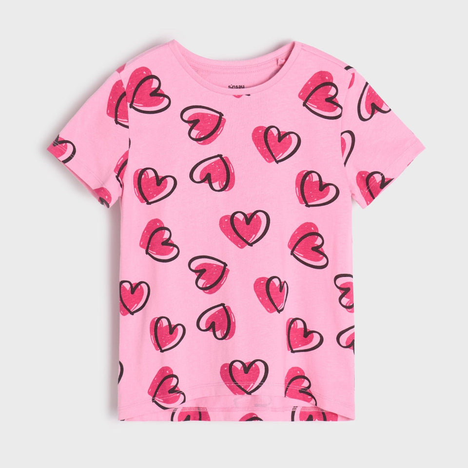 Pink t-shirt with red heart patterns on a light gray background