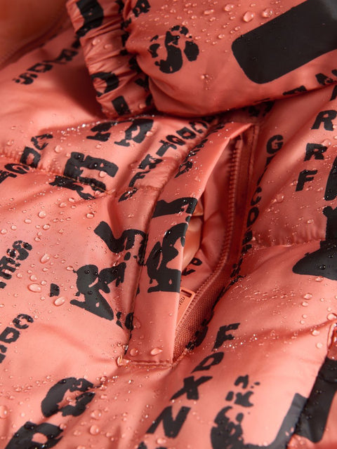Close-up of a pink jacket with black text pattern