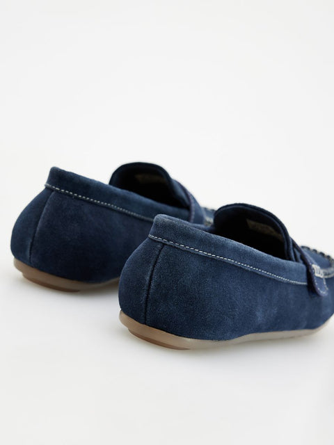 Pair of blue loafers on a white background