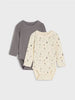 Two baby bodysuits, one gray and one with a pattern, on a light gray background.