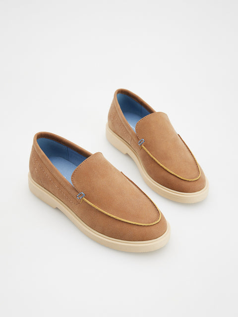 Pair of brown suede loafers on a white background