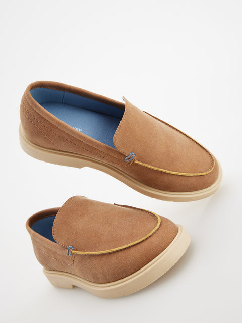 Pair of brown loafers with blue lining on a white background
