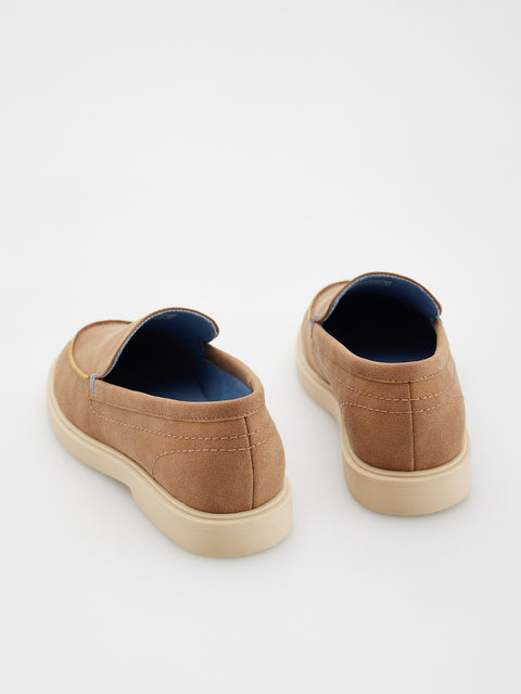 Pair of brown slip-on shoes on a white background