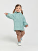 Child wearing a light blue quilted jacket on a white background