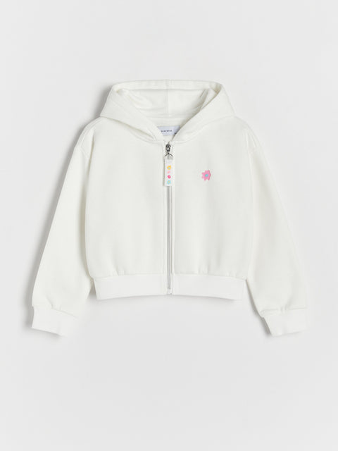 White hoodie with a small logo on a light gray background