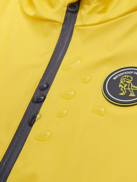 Yellow raincoat with a waterproof label on a yellow background