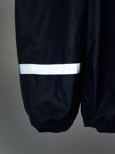 Black raincoat with reflective strip on a gray background