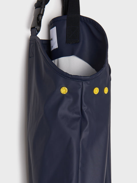 Navy raincoat with yellow buttons on a white background
