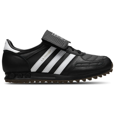 Black and white athletic shoe with cleats on a white background