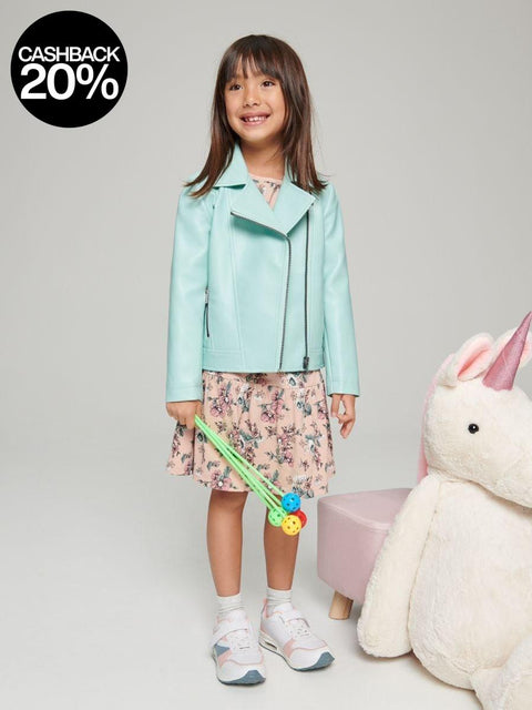 A girl wearing a light blue biker jacket with a classic collar, zip fastening, and two pockets, standing next to a plush unicorn toy.