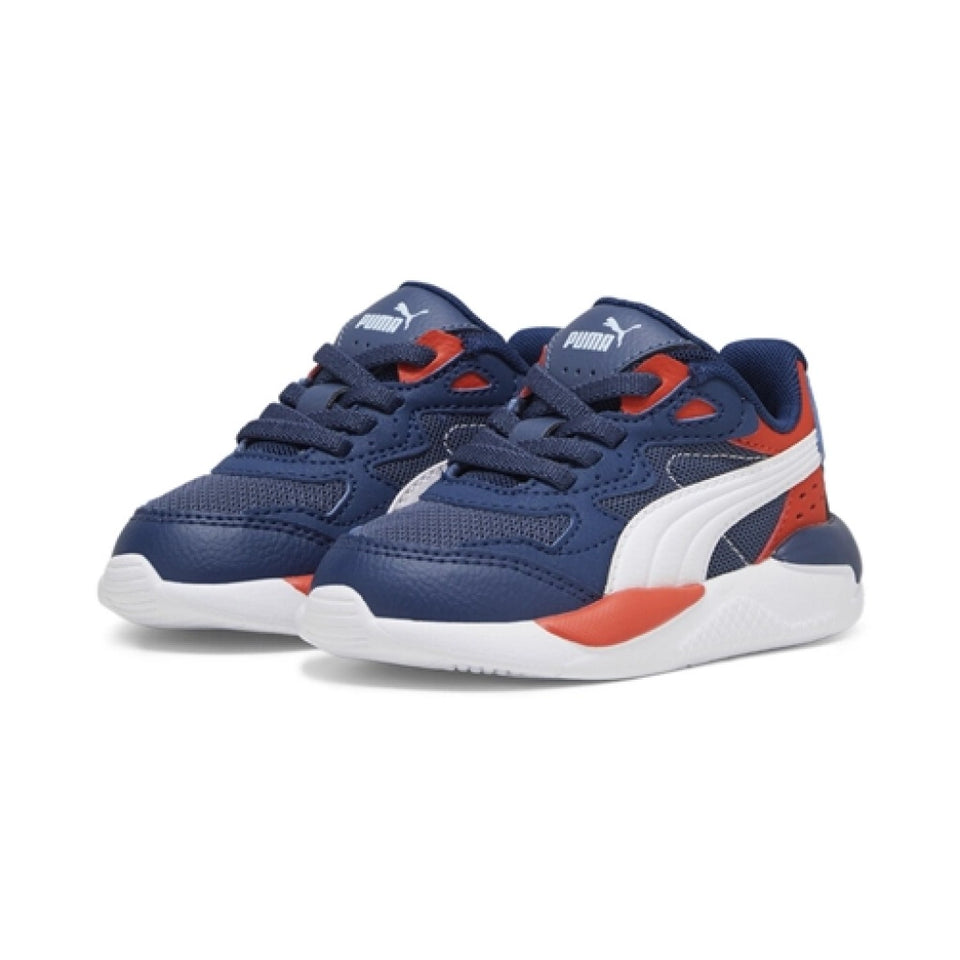 A pair of Puma sneakers in navy blue, white, and orange-red, shown against a plain white background.