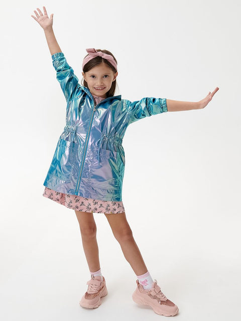 Child wearing a colorful raincoat with arms outstretched on a white background