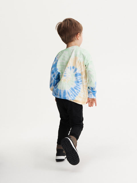 Child wearing a tie-dye hoodie on a white background