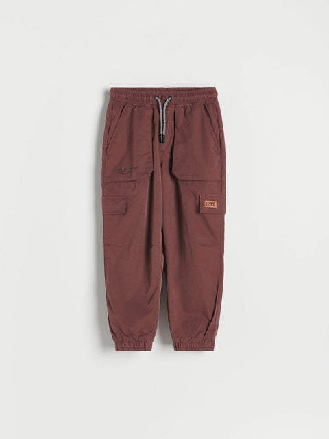 Brown cargo jogger pants on a light gray background