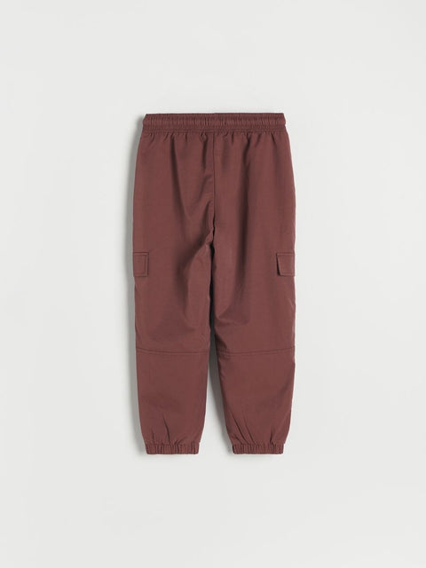Brown jogger pants on a light gray background
