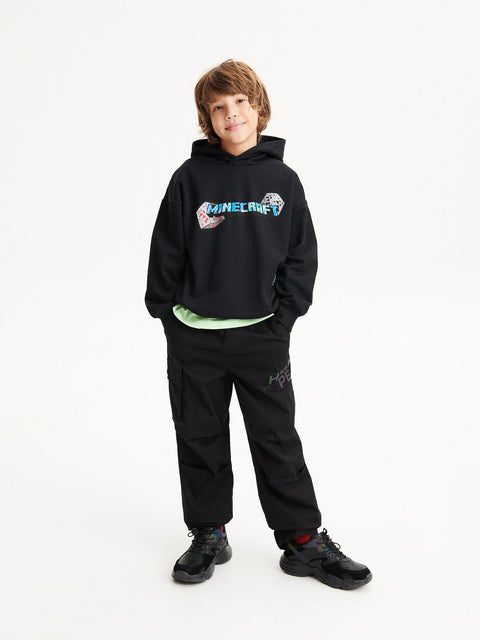 Child wearing a black hoodie with a colorful design on a white background