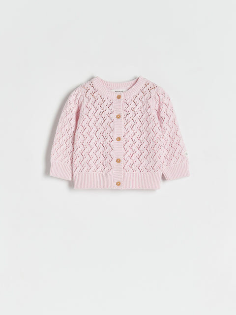 Pink knitted cardigan with button details on a light gray background