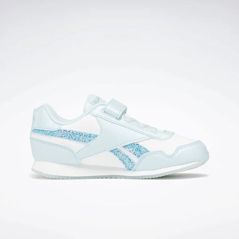 A Reebok kids' sneaker in light blue and white, featuring a white leather upper with light blue glittery Reebok vector stripes and a matching light blue hook-and-loop strap closure.