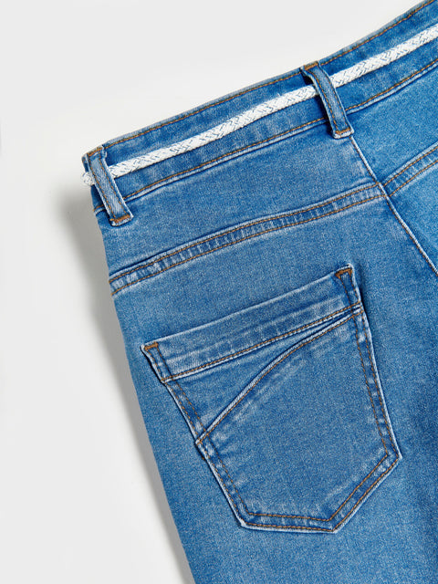 Close-up of blue jeans with a white background