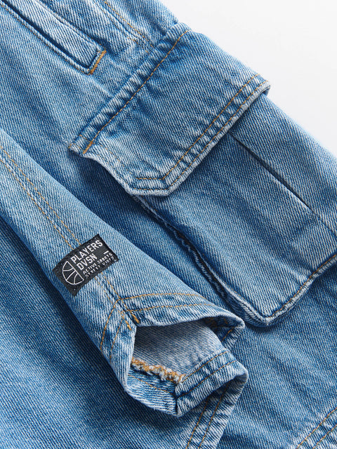 Close-up of blue denim jeans with a brand label on a white background
