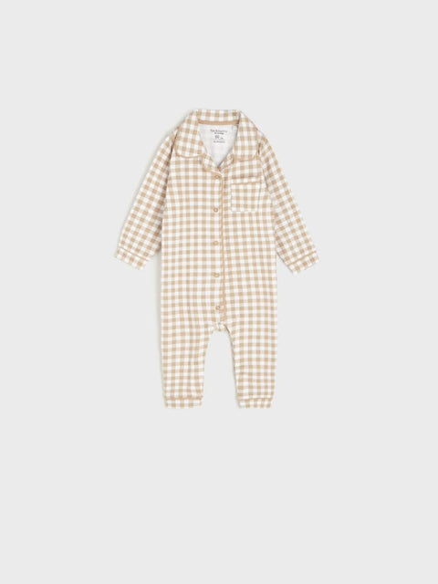 Checkered baby onesie on a light gray background