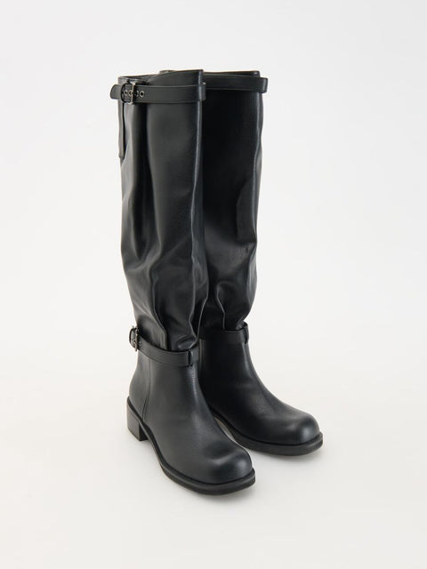 Black knee-high boots with buckles on a white background