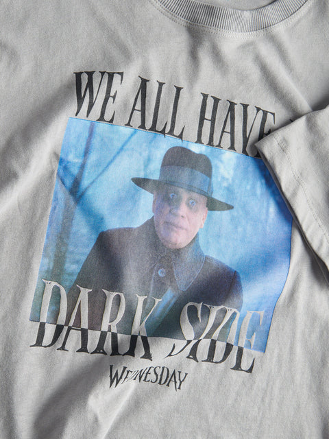 Gray t-shirt with a graphic of a person wearing a hat and text 'WE ALL HAVE DARK SIDE WEDNESDAY' on a blue background.