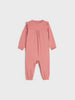 Pink baby jumpsuit on a light gray background