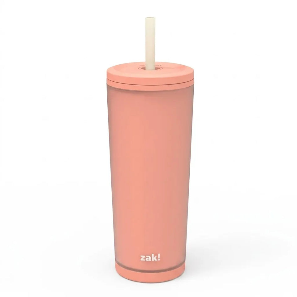 A tall, matte peach-colored insulated tumbler with a matching lid and a light beige straw, featuring the 'zak!' logo near the bottom, set against a plain white background.