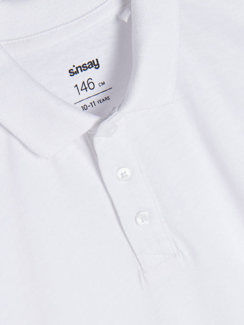 White shirt with 'sinsay' branding and size label on a white background