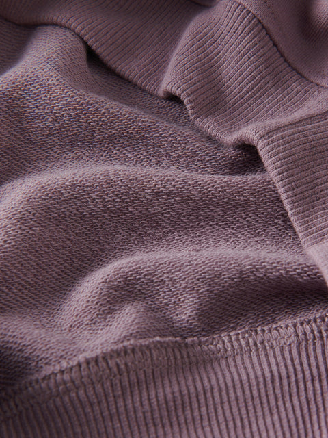 Close-up of a textured purple fabric surface