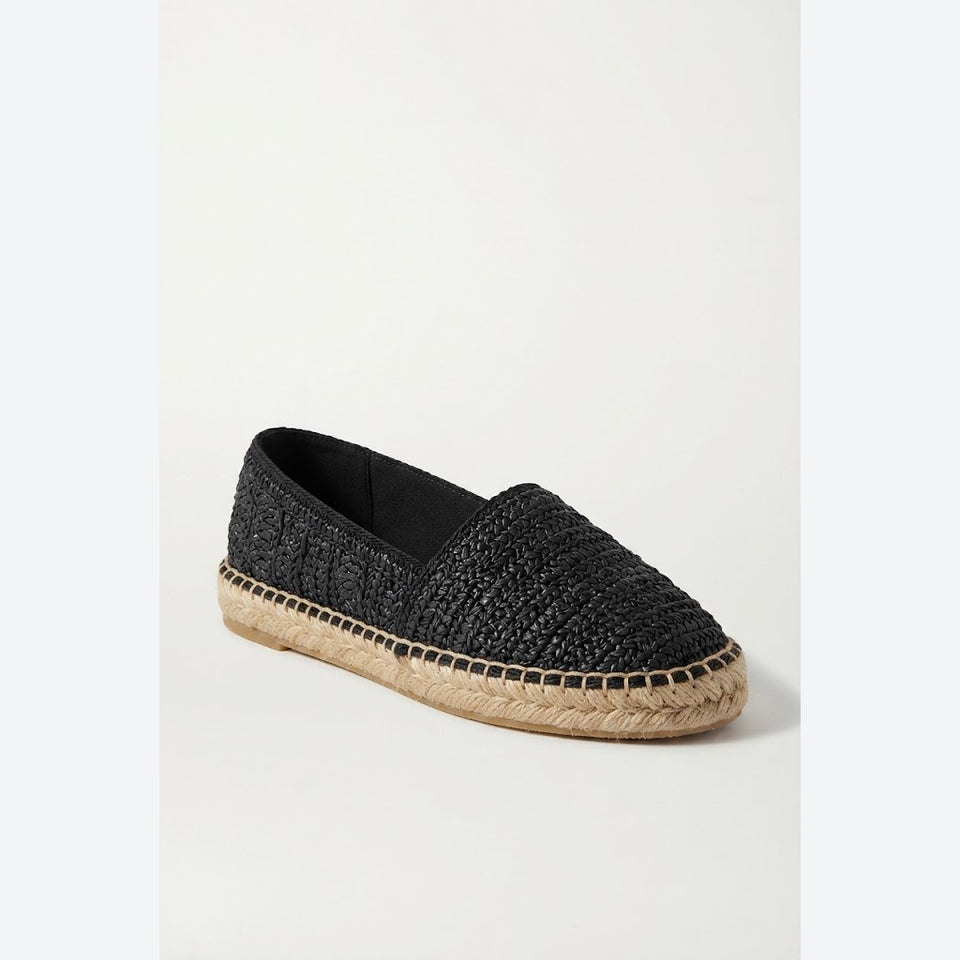 A single black woven slip-on espadrille shoe with a natural jute-wrapped platform sole, shown from a three-quarters angle on a light off-white background.