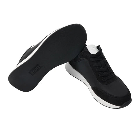 Black sneakers with white soles on a white background