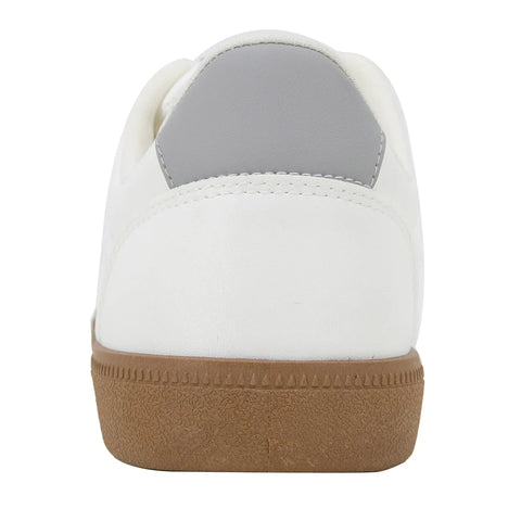 White sneaker with a brown sole on a white background