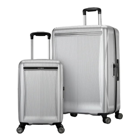 Two silver suitcases with black handles and wheels on a white background
