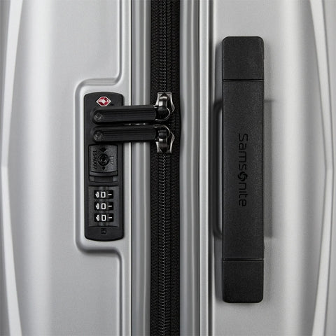 Close-up of a Samsonite suitcase with a combination lock and keyless lock mechanism.