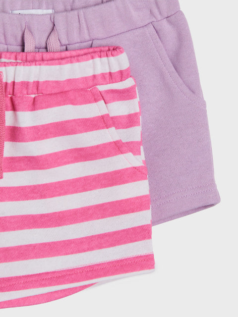 Pink and white striped shorts with a purple fabric background