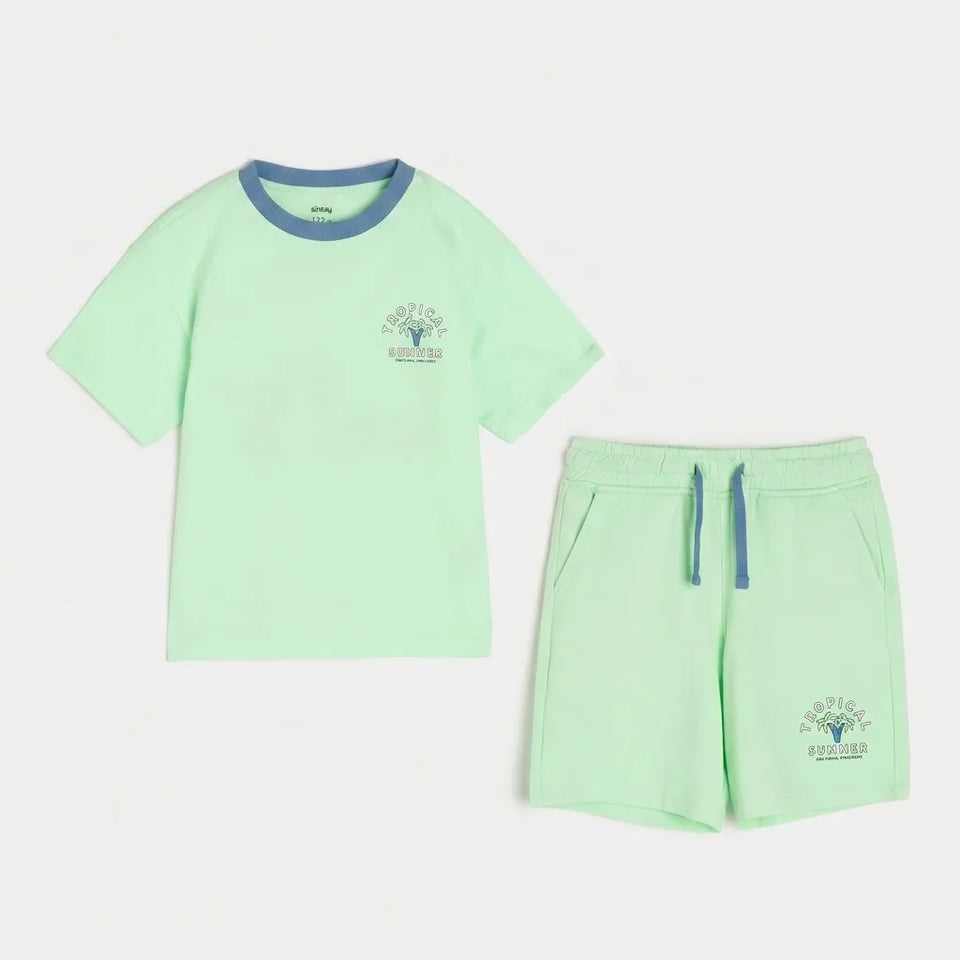 A two-piece kids' loungewear set in mint green, featuring a short-sleeve ringer t-shirt with a contrasting blue crew neck and a matching pair of drawstring shorts with blue drawstrings and a small chest graphic.