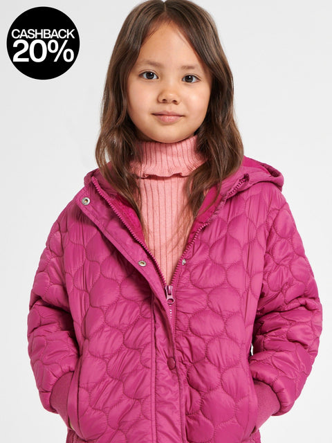 Child wearing a pink quilted jacket on a white background