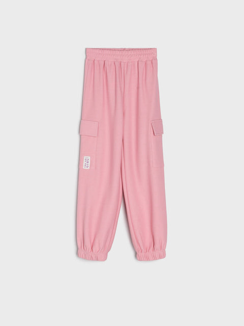 Pink pants with a small white label on a light gray background