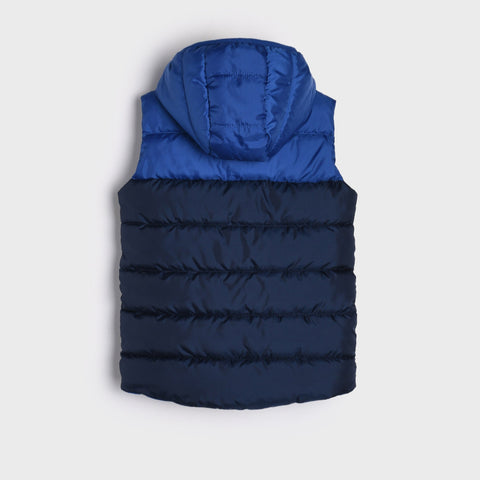 Blue and navy puffer vest on a light gray background