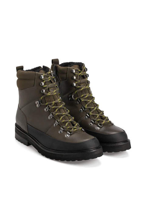 Pair of brown hiking boots with black soles on a white background