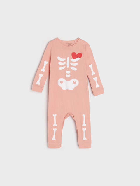 Pink baby onesie with skeleton design on a light gray background