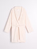 Cream-colored robe on a light gray background